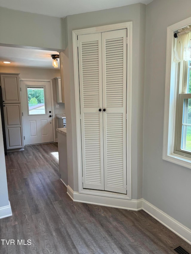 hall with dark hardwood / wood-style flooring