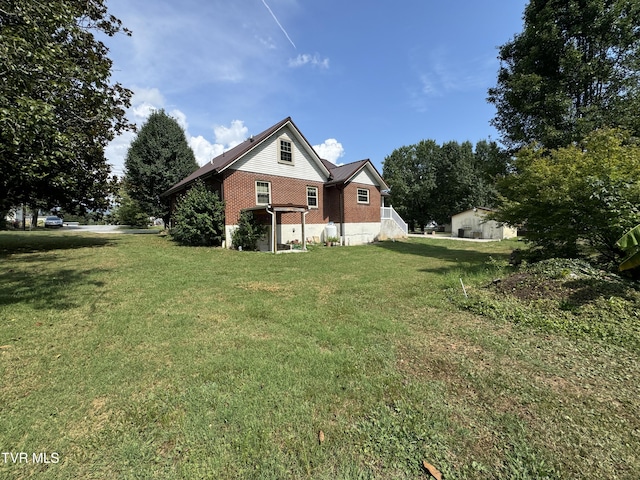 exterior space featuring brick siding and a front lawn