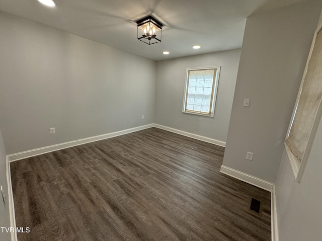 spare room with recessed lighting, visible vents, baseboards, and dark wood-style floors