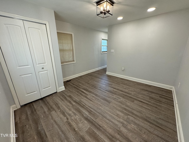 interior space featuring visible vents, baseboards, a chandelier, recessed lighting, and dark wood-style flooring