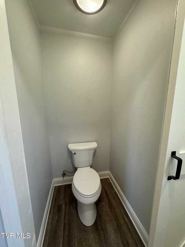 bathroom featuring toilet and wood-type flooring