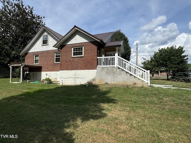 view of property exterior featuring a standing seam roof, a yard, brick siding, and metal roof