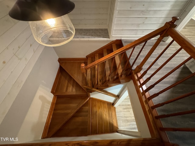 stairs with wood walls