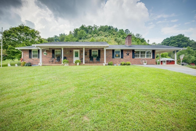 ranch-style home with a front yard and a carport