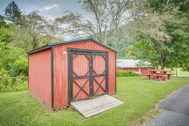 view of outbuilding featuring a lawn