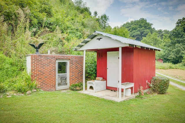 view of outbuilding featuring a lawn and ac unit