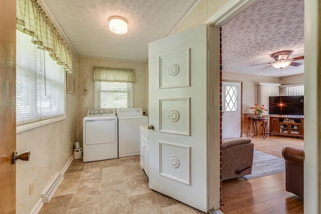 washroom featuring a textured ceiling, separate washer and dryer, and ceiling fan