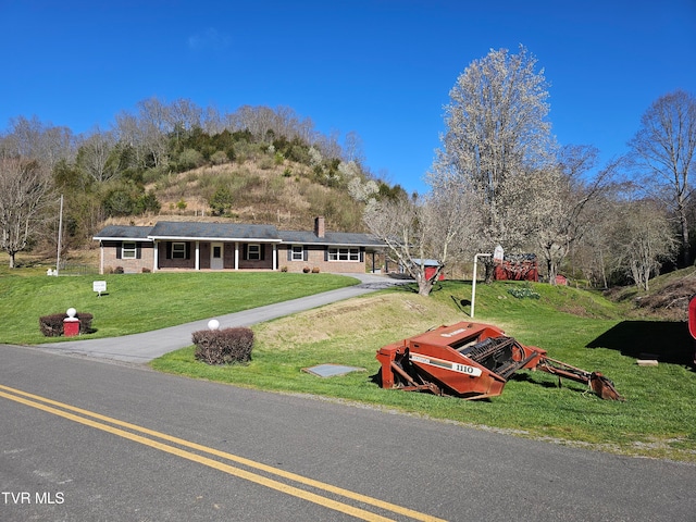 single story home featuring a front yard and solar panels