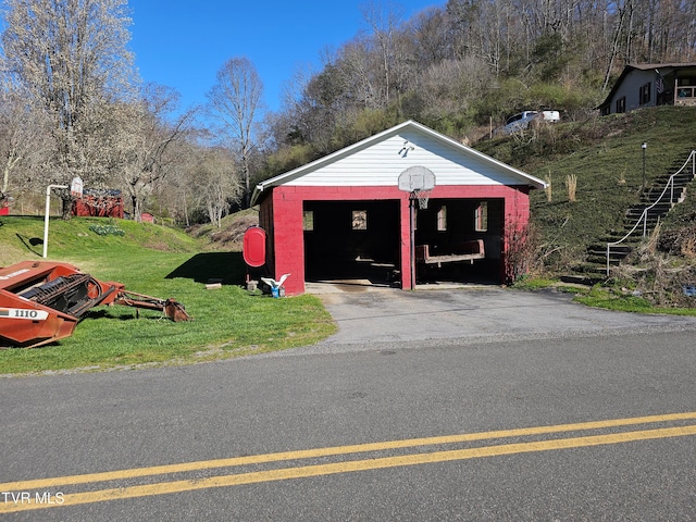 view of outdoor structure with a yard and a garage