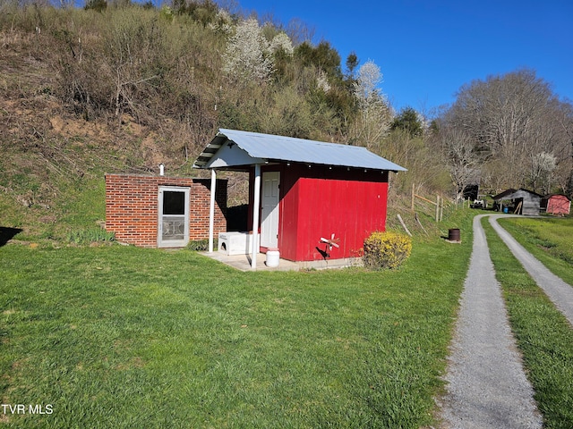 view of outbuilding featuring a lawn