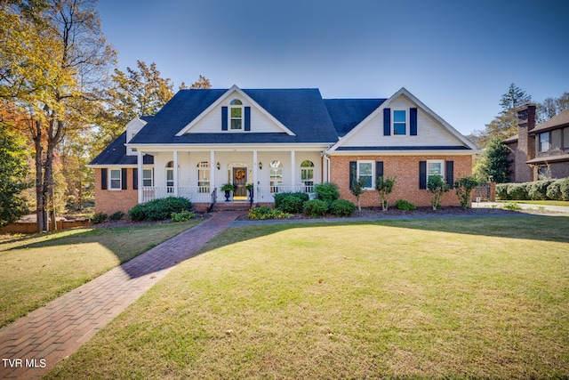 view of front of house with covered porch and a front yard