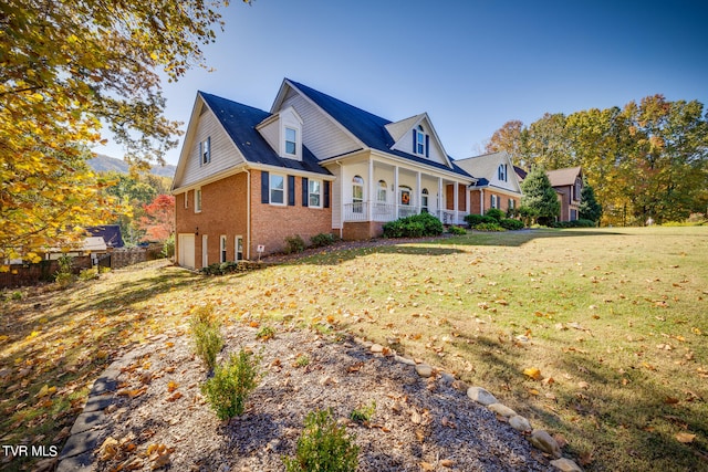 view of front of property with covered porch and a front yard