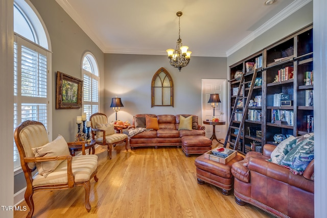 living room with an inviting chandelier, crown molding, and light hardwood / wood-style floors