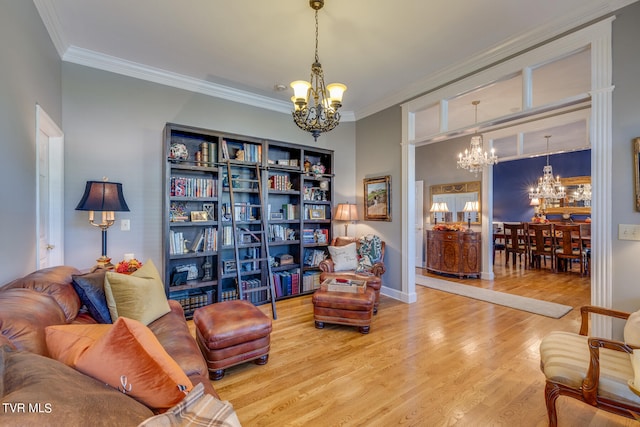 living area featuring ornamental molding, a notable chandelier, and light hardwood / wood-style flooring