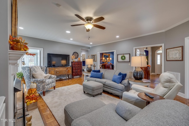 living room with ceiling fan, light parquet floors, and ornamental molding