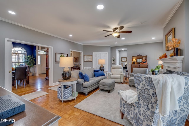 living room featuring light parquet floors, ceiling fan, and ornamental molding