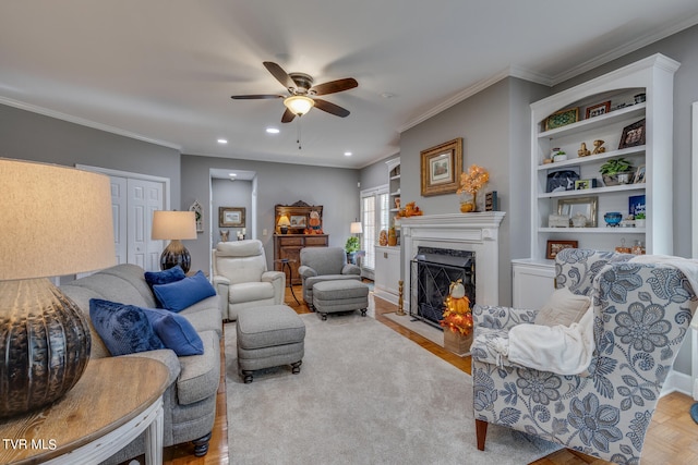 living room with ceiling fan, crown molding, light parquet flooring, and a premium fireplace