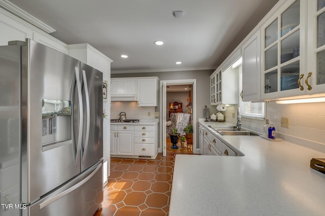 kitchen with backsplash, sink, dark tile floors, stainless steel refrigerator with ice dispenser, and white cabinets