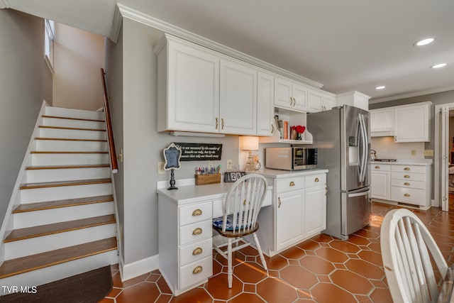 office area with dark tile floors and crown molding