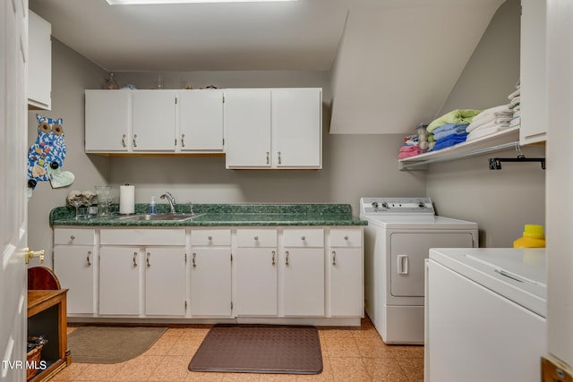 laundry room with sink, cabinets, washer and clothes dryer, and light tile floors