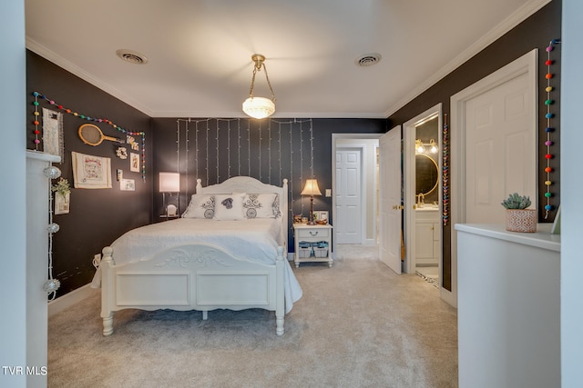 carpeted bedroom featuring ornamental molding and ensuite bathroom