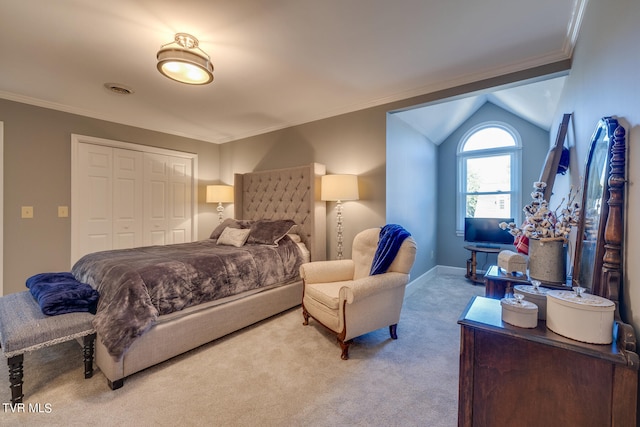 carpeted bedroom with crown molding, a closet, and vaulted ceiling