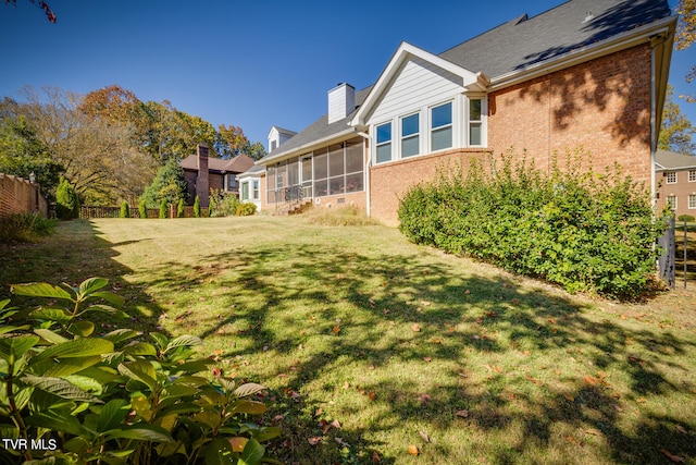 view of yard with a sunroom