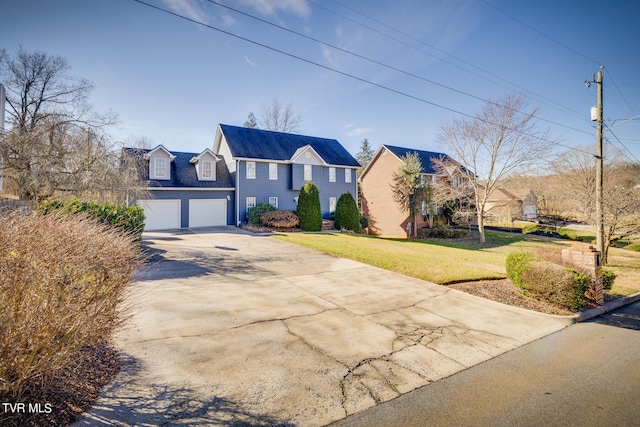 view of front of house with a garage and a front yard