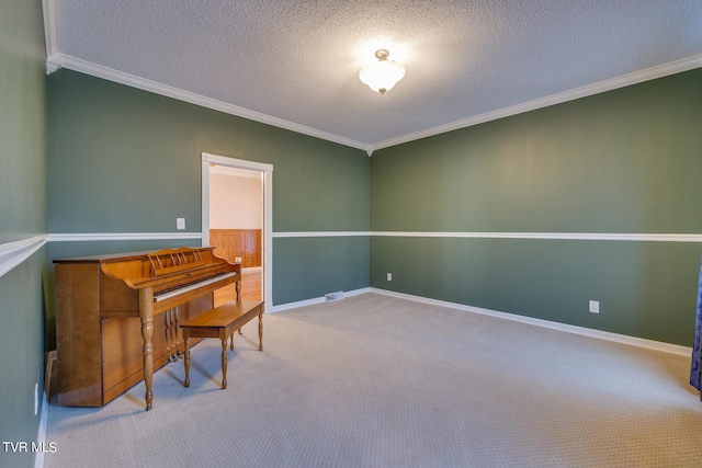 carpeted spare room featuring a textured ceiling and crown molding