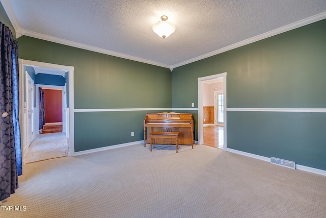 sitting room featuring a textured ceiling, carpet, and ornamental molding