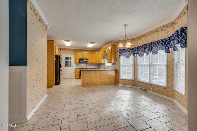 kitchen with backsplash, pendant lighting, light tile patterned floors, black appliances, and crown molding