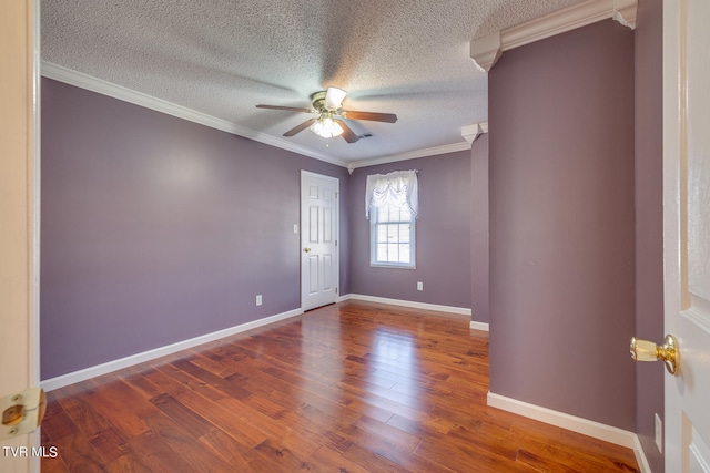 spare room with hardwood / wood-style flooring, a textured ceiling, crown molding, and ceiling fan