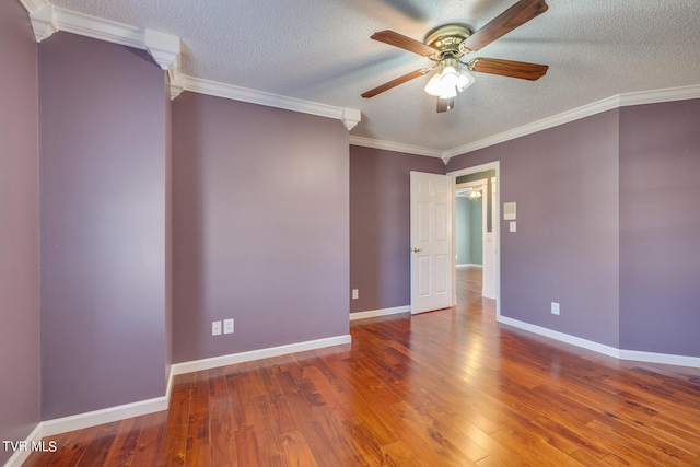 empty room with hardwood / wood-style floors, ornamental molding, ceiling fan, and a textured ceiling