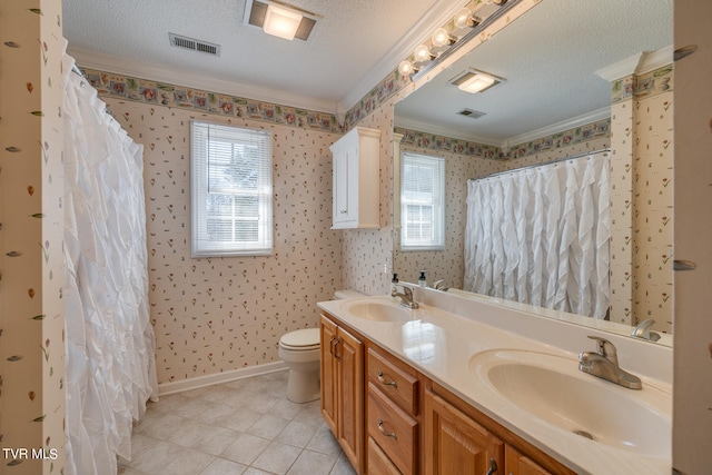 bathroom with double sink vanity, ornamental molding, tile patterned floors, a textured ceiling, and toilet