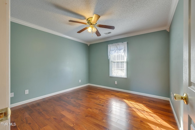 empty room with ceiling fan, hardwood / wood-style flooring, crown molding, and a textured ceiling