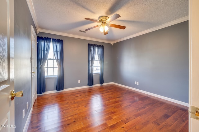 empty room featuring hardwood / wood-style flooring, crown molding, and ceiling fan