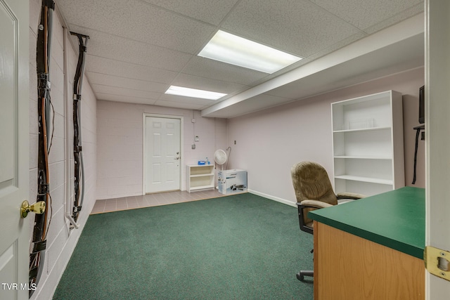 unfurnished office featuring carpet and a paneled ceiling