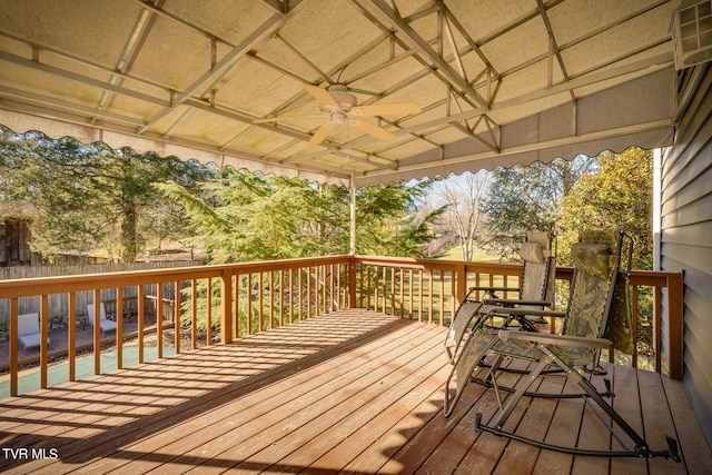 deck with ceiling fan and a pool