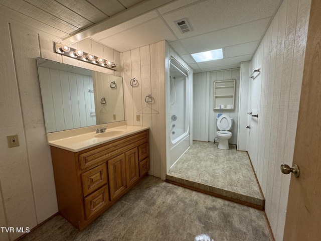 full bathroom with vanity, wood walls, toilet, and tub / shower combination