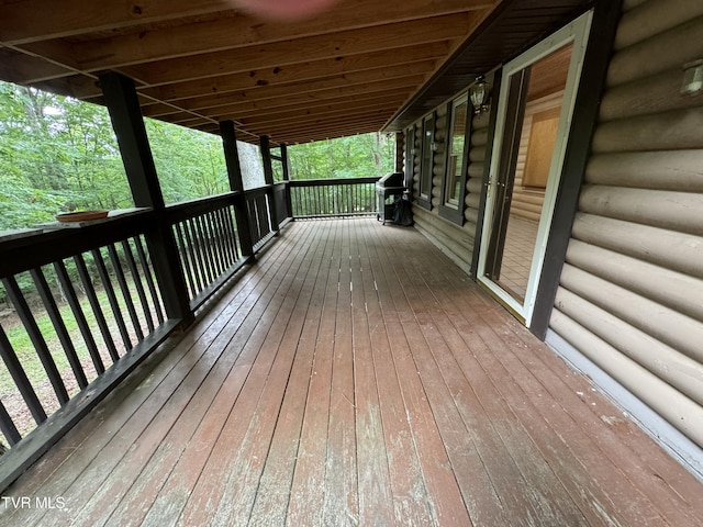 wooden terrace with a grill