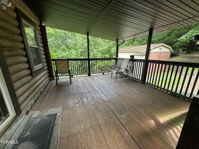 wooden terrace featuring a shed