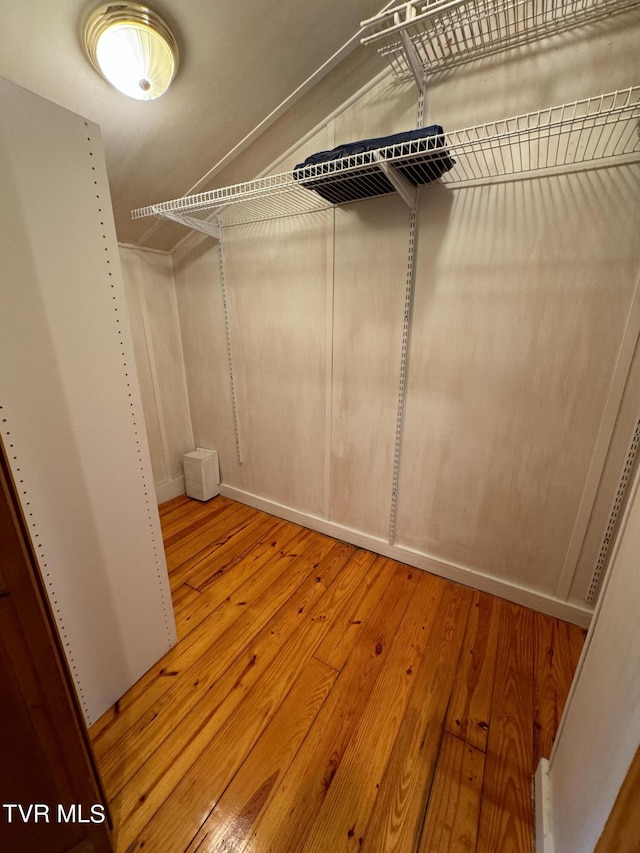 spacious closet featuring vaulted ceiling and light wood-type flooring