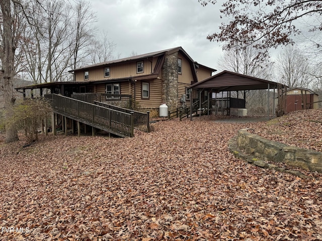 back of property with a gazebo and a wooden deck