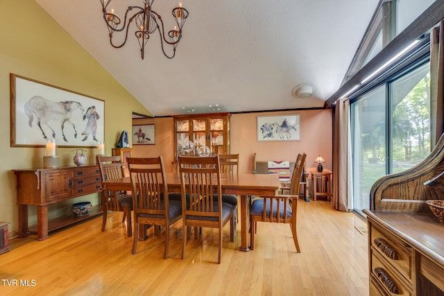 117 Lakeside Dr, Gray, TN 37615 - dining area with lofted ceiling, light hardwood / wood-style floors, and a notable chandelier