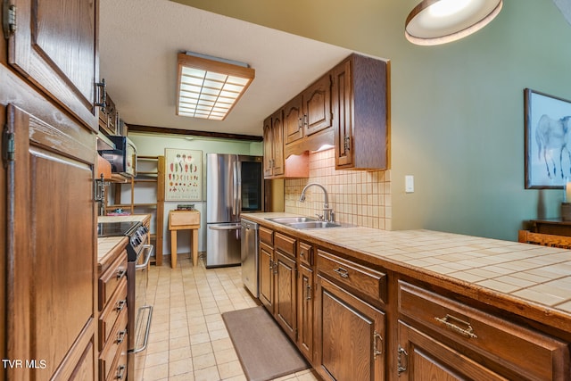 117 Lakeside Dr, Gray, TN 37615 - kitchen featuring sink, light tile patterned floors, stainless steel appliances, decorative backsplash, and tile countertops