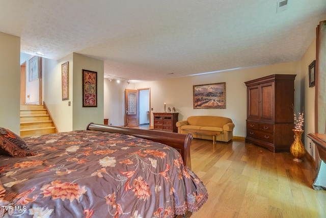 117 Lakeside Dr, Gray, TN 37615 - bedroom with a textured ceiling and light hardwood / wood-style flooring
