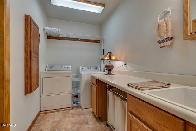 117 Lakeside Dr, Gray, TN 37615 - clothes washing area featuring cabinets, sink, washing machine and dryer, and light tile patterned floors
