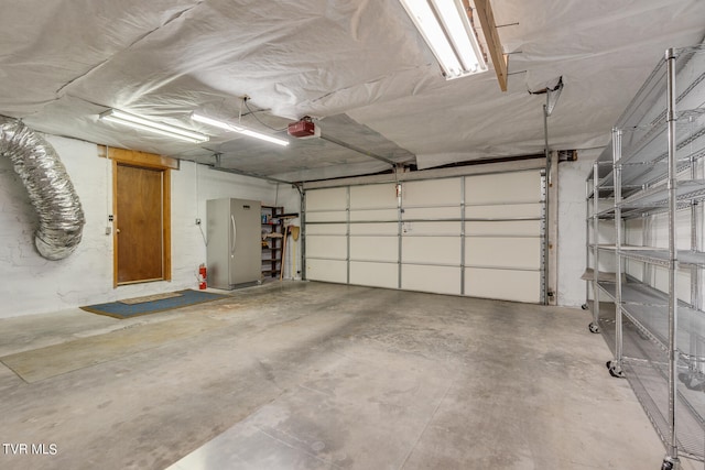 117 Lakeside Dr, Gray, TN 37615 - garage featuring a garage door opener and stainless steel fridge