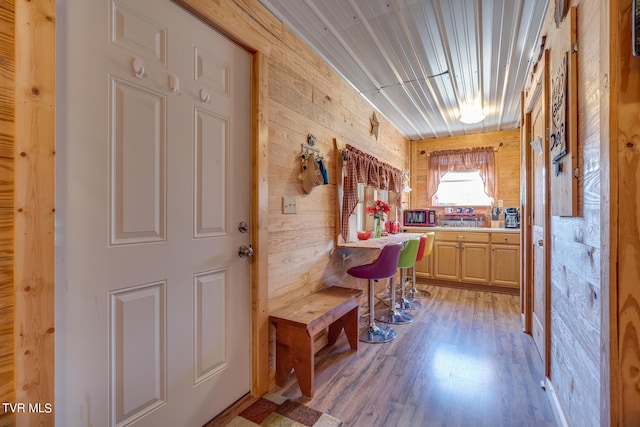 interior space with wooden walls and light hardwood / wood-style flooring