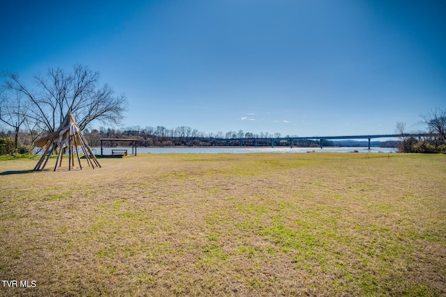 view of yard with a playground and a water view